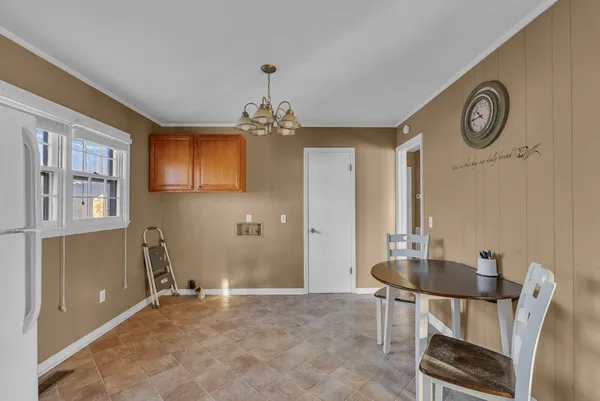 a view of a room with a table and chairs
