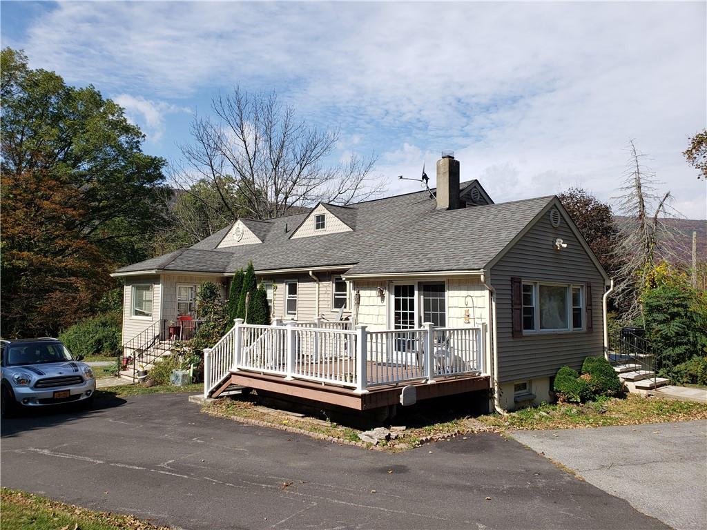 a front view of a house with a garden and porch