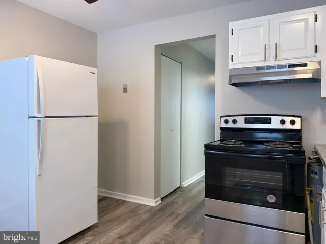 a stove top oven sitting inside of a kitchen