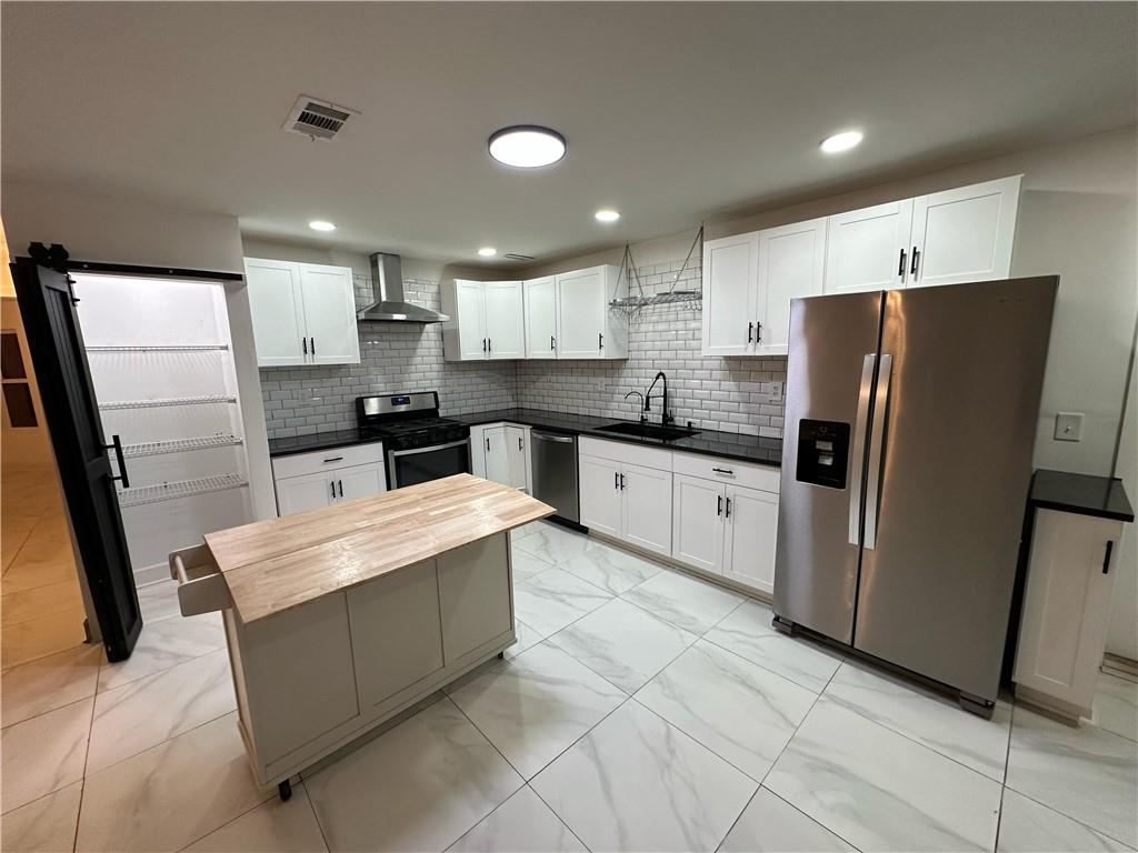 3479 Clare Cottage Trace Southwest Austell, GA 30106 - Photo 11 of 40 a kitchen with stainless steel appliances a refrigerator sink and microwave