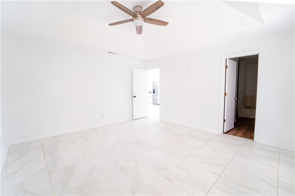 3479 Clare Cottage Trace Southwest Austell, GA 30106 - Photo 14 of 40 an empty room with a ceiling fan and a window