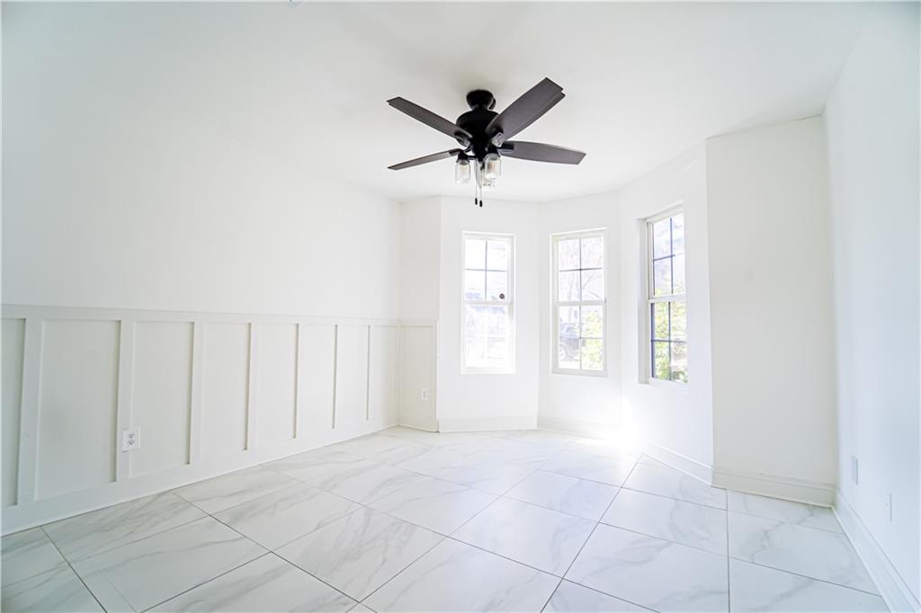 3479 Clare Cottage Trace Southwest Austell, GA 30106 - Photo 20 of 40 a view of a livingroom with a chandelier fan and windows