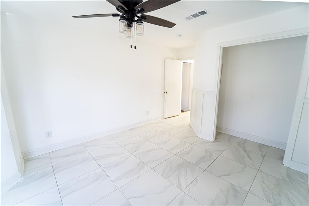 3479 Clare Cottage Trace Southwest Austell, GA 30106 - Photo 22 of 40 an empty room with white walls and ceiling fan