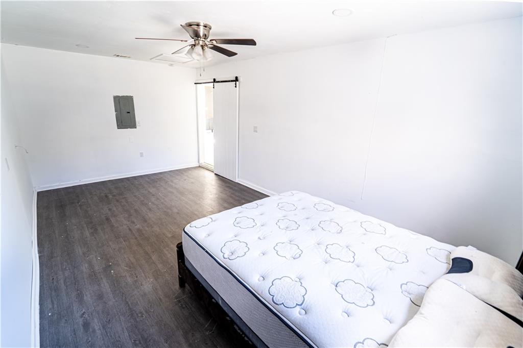 3479 Clare Cottage Trace Southwest Austell, GA 30106 - Photo 25 of 40 a view of a bedroom with wooden floor and a ceiling fan