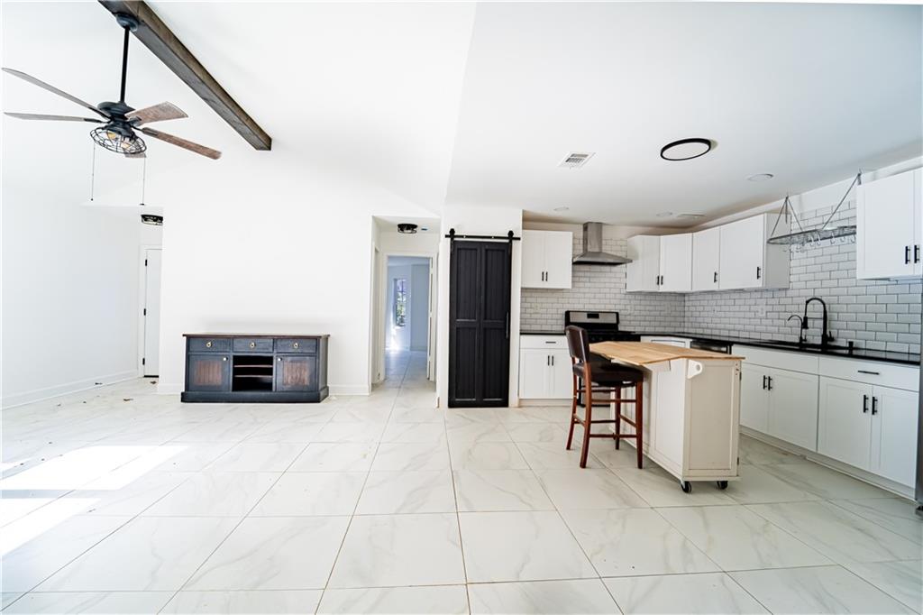 3479 Clare Cottage Trace Southwest Austell, GA 30106 - Photo 7 of 40 a kitchen with stainless steel appliances granite countertop a refrigerator and a stove top oven