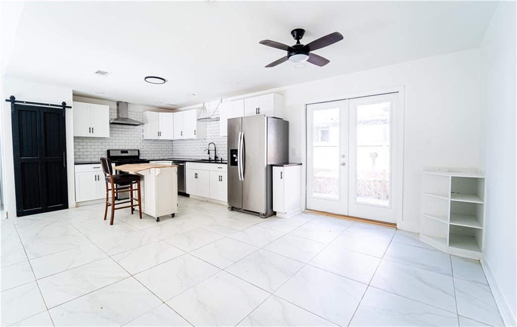 3479 Clare Cottage Trace Southwest Austell, GA 30106 - Photo 8 of 40 a view of kitchen with stainless steel appliances kitchen island hardwood floor and a window