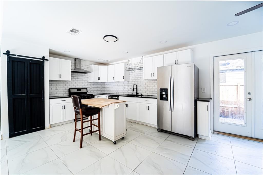 3479 Clare Cottage Trace Southwest Austell, GA 30106 - Photo 9 of 40 a kitchen with stainless steel appliances a refrigerator sink and cabinets
