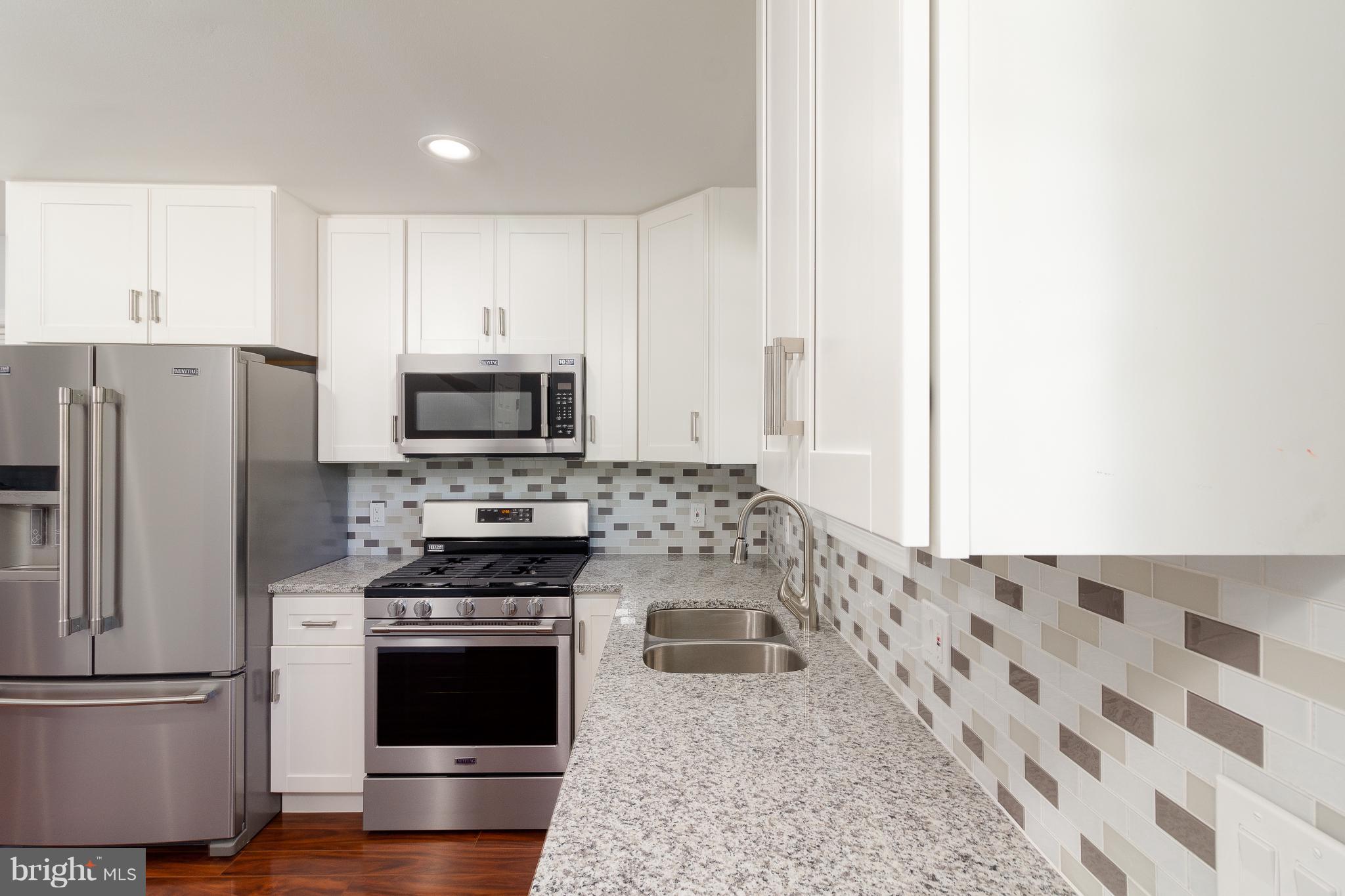 7700 Bender Road Landover, MD 20785 - Photo 2 of 13 a kitchen with stainless steel appliances granite countertop a refrigerator stove and sink