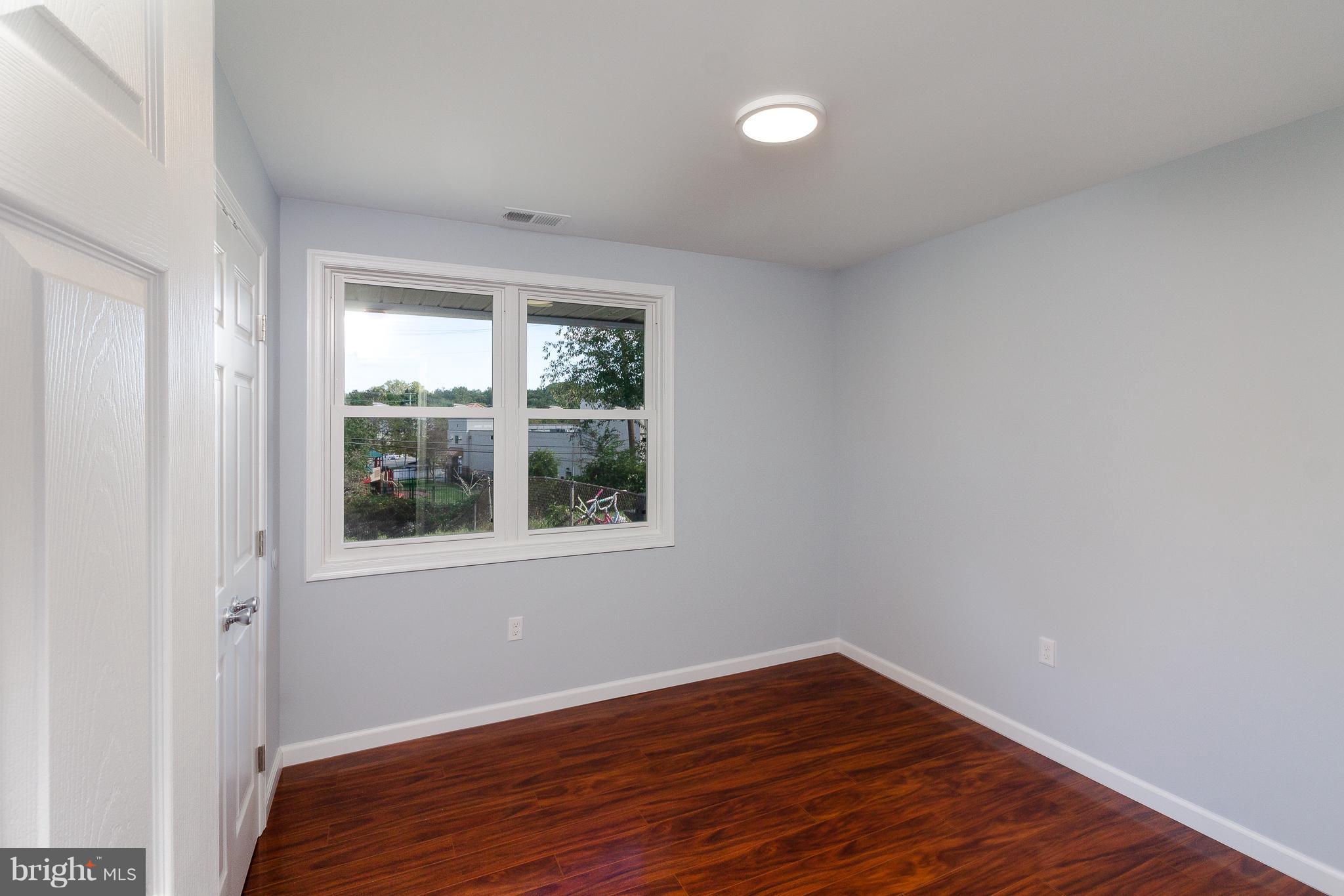 7700 Bender Road Landover, MD 20785 - Photo 11 of 13 a view of an empty room with wooden floor and a window
