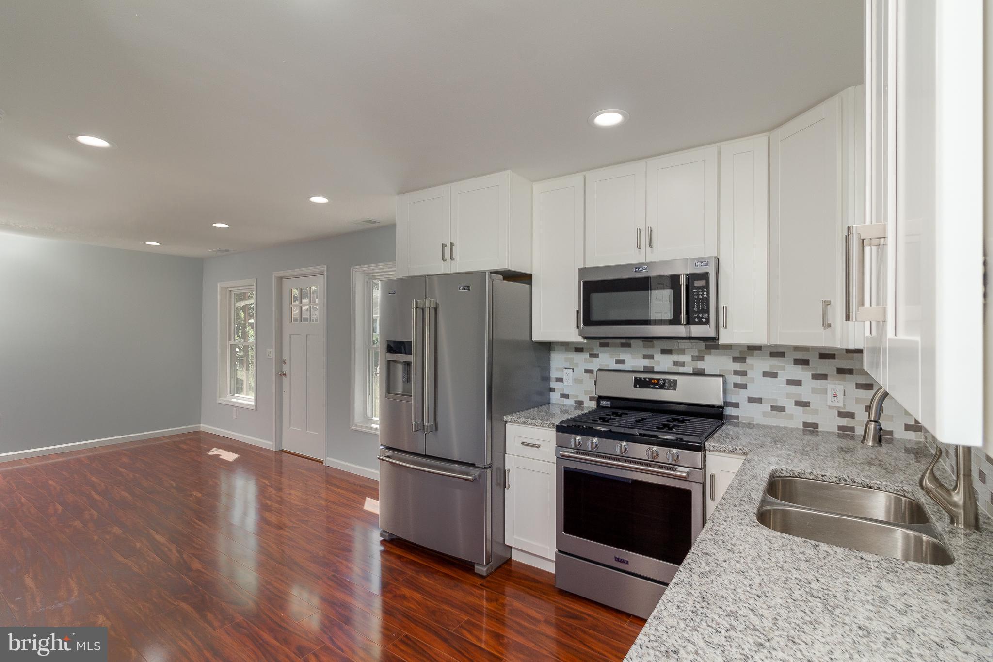 7700 Bender Road Landover, MD 20785 - Photo 3 of 13 a kitchen with stainless steel appliances granite countertop a refrigerator stove and oven