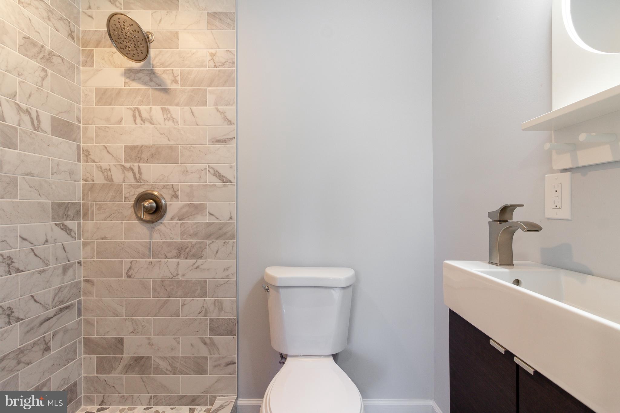 7700 Bender Road Landover, MD 20785 - Photo 6 of 13 a bathroom with a toilet a sink and mirror
