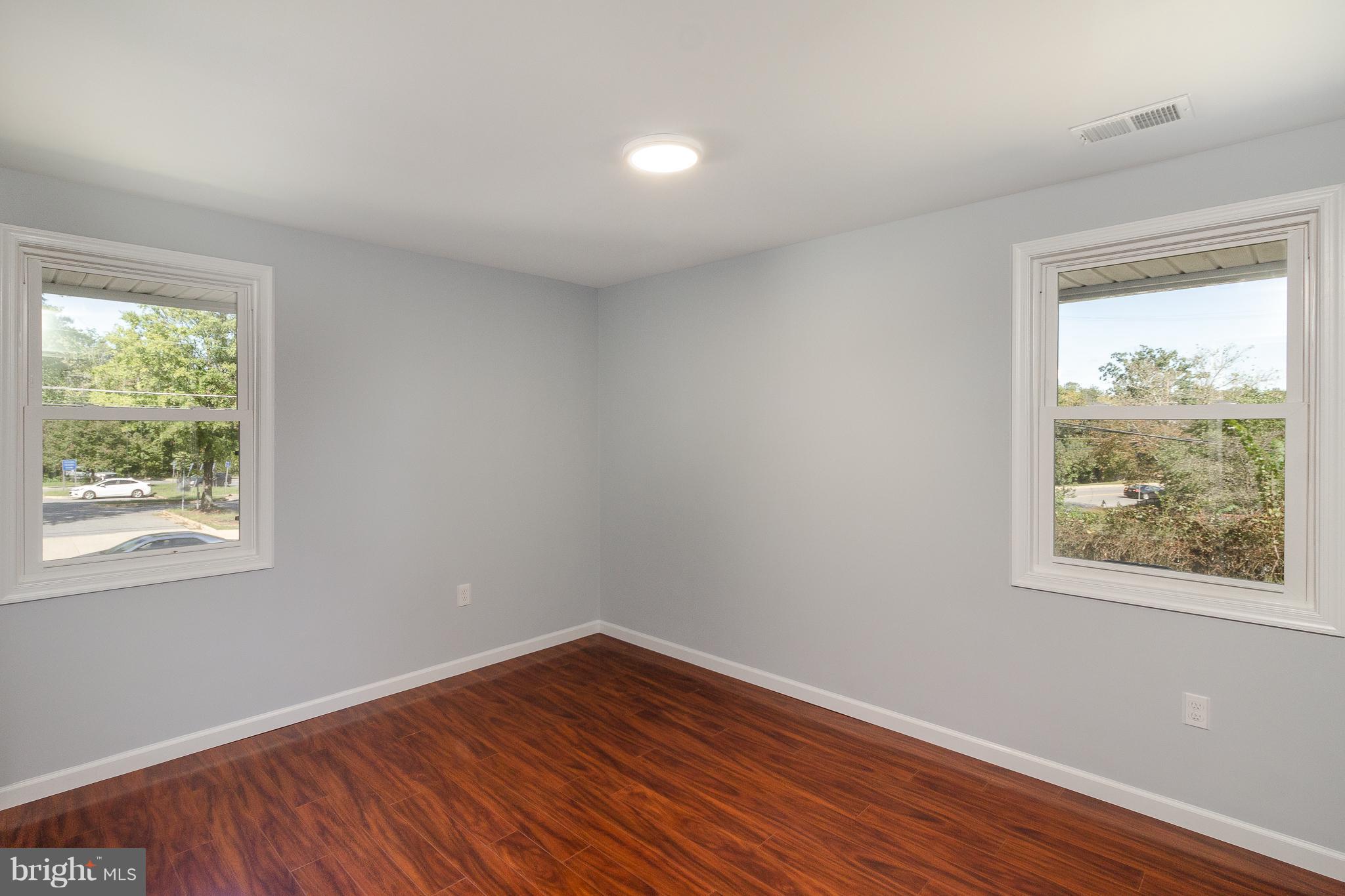 7700 Bender Road Landover, MD 20785 - Photo 8 of 13 a view of an empty room with wooden floor and a window