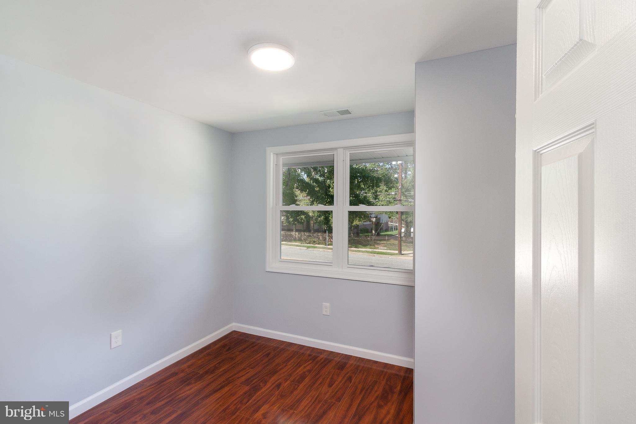 7700 Bender Road Landover, MD 20785 - Photo 10 of 13 an empty room with wooden floor and windows