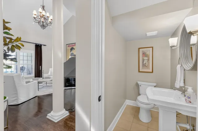 a living room with furniture and paintings on the wall