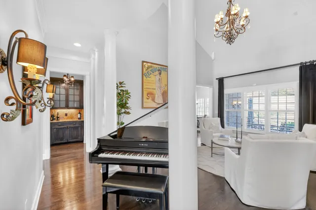 a living room with furniture a rug and a chandelier