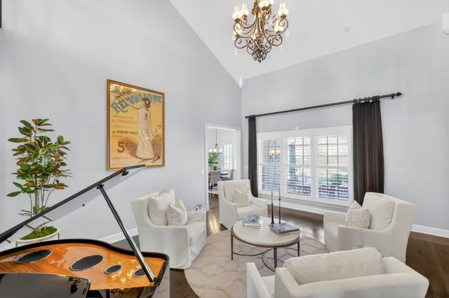 a living room with furniture and a chandelier