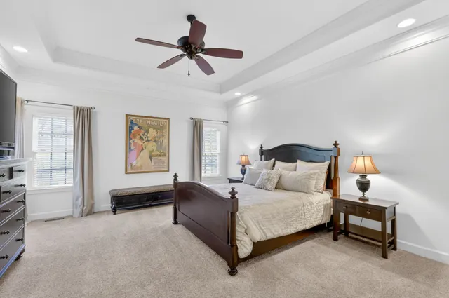 a spacious bathroom with a granite countertop sink a toilet and a large mirror