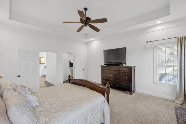 a very nice looking kitchen with granite countertop a stove oven and a flat screen tv