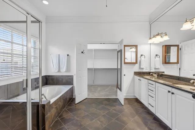 a kitchen with granite countertop a table chairs stove and wooden floor