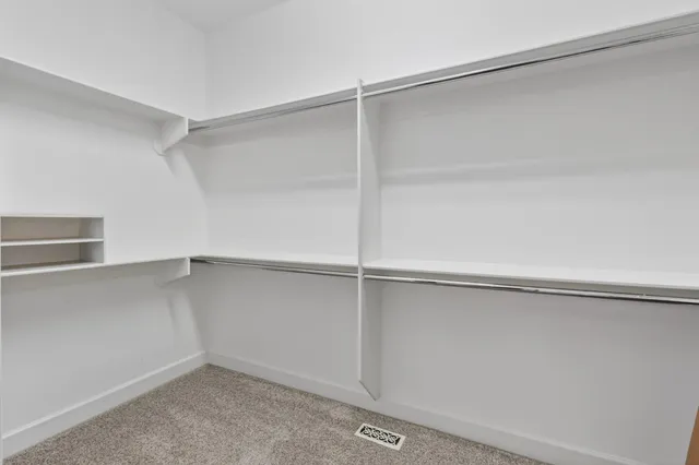 a kitchen with stainless steel appliances granite countertop a stove top oven a sink dishwasher and a microwave oven with wooden floor