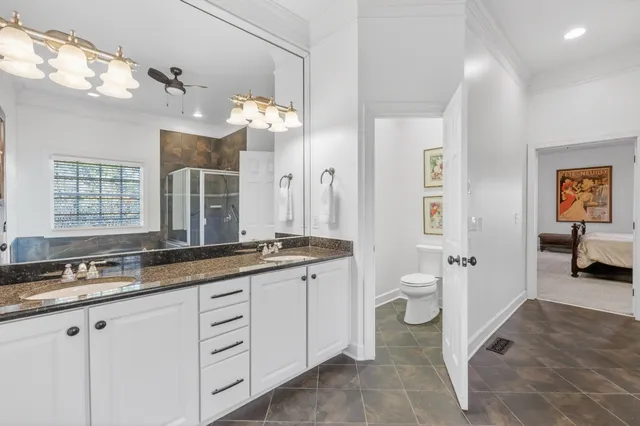 a kitchen with stainless steel appliances granite countertop a kitchen island a stove a refrigerator cabinets and wooden floor