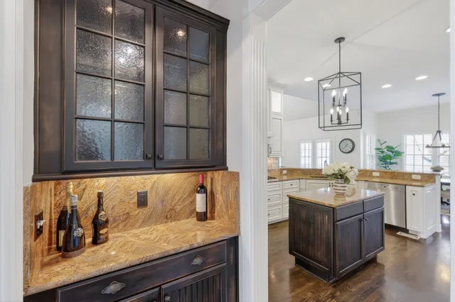 a living room with furniture a dining table and a chandelier