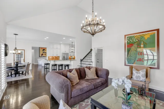 a view of a hallway with wooden floor and stairs