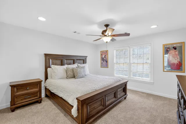 a view of a patio with couches table and chairs and potted plants