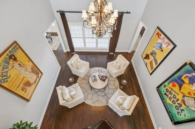 a view of a house with a big yard and large trees