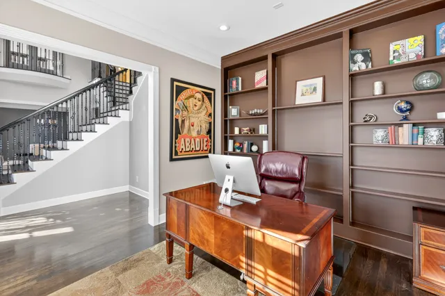 a view of a dining room with furniture a chandelier and wooden floor