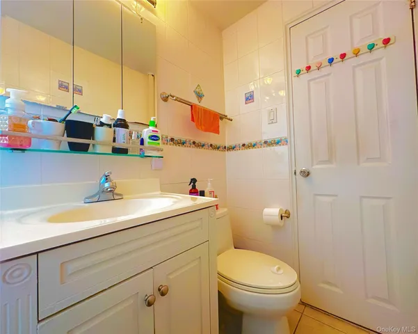 a bathroom with a sink a toilet and shower curtain