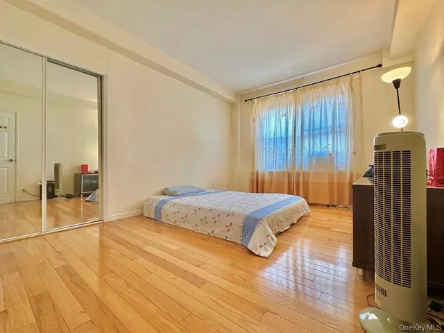 a spacious bedroom with a bed and a dresser