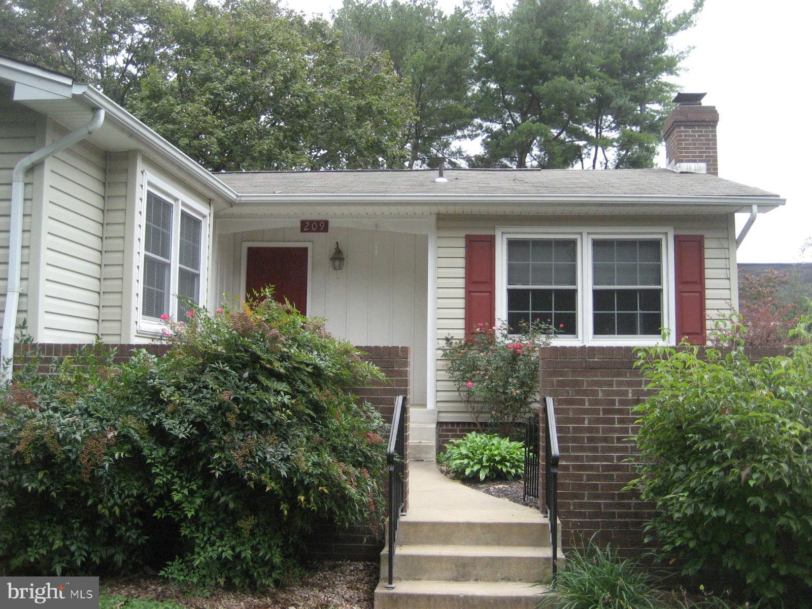 209 Dover Road Warrenton, VA 20186 - Photo 1 of 30 a front view of a house with plants