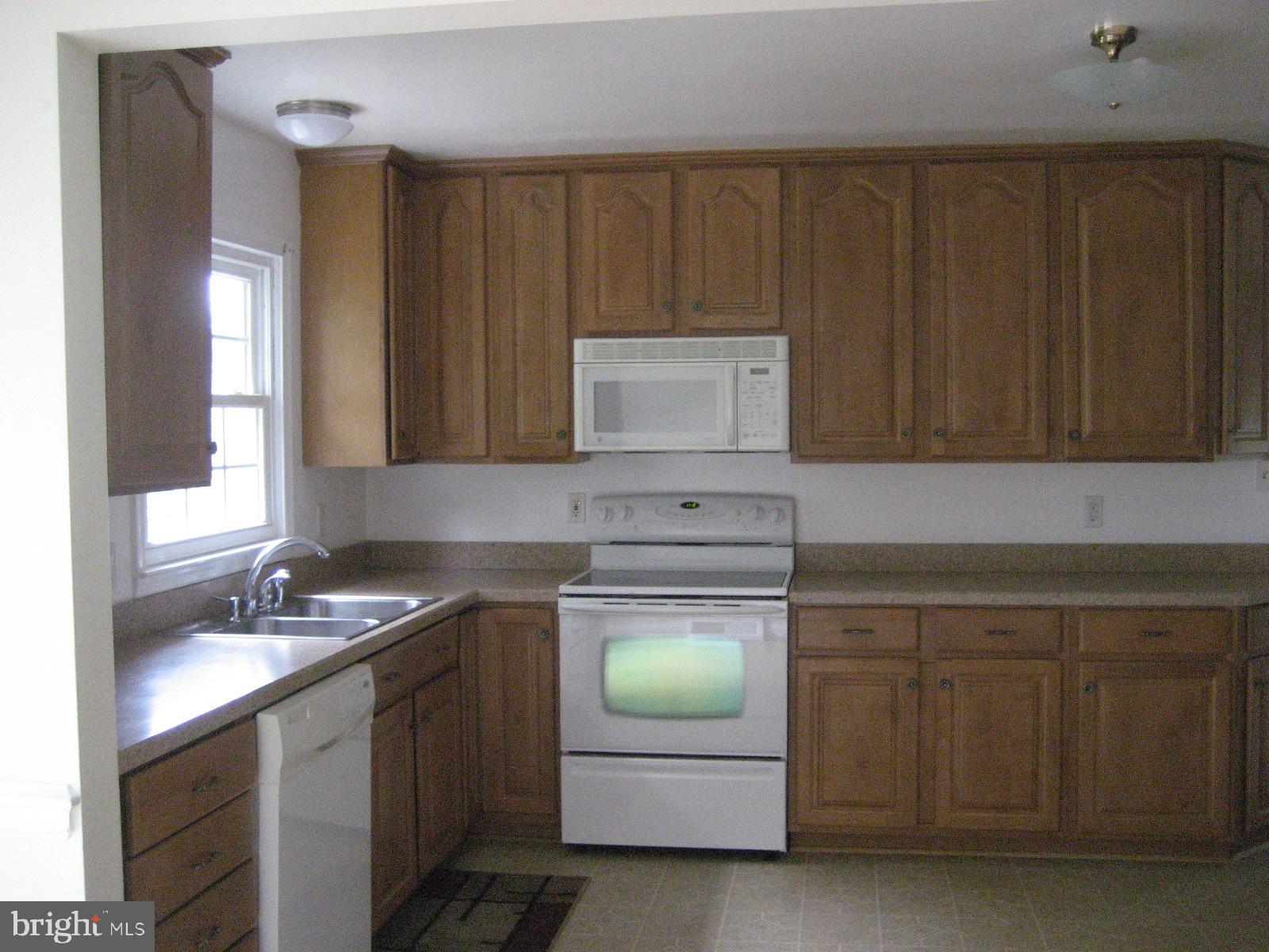 209 Dover Road Warrenton, VA 20186 - Photo 11 of 30 a kitchen with sink cabinets and window