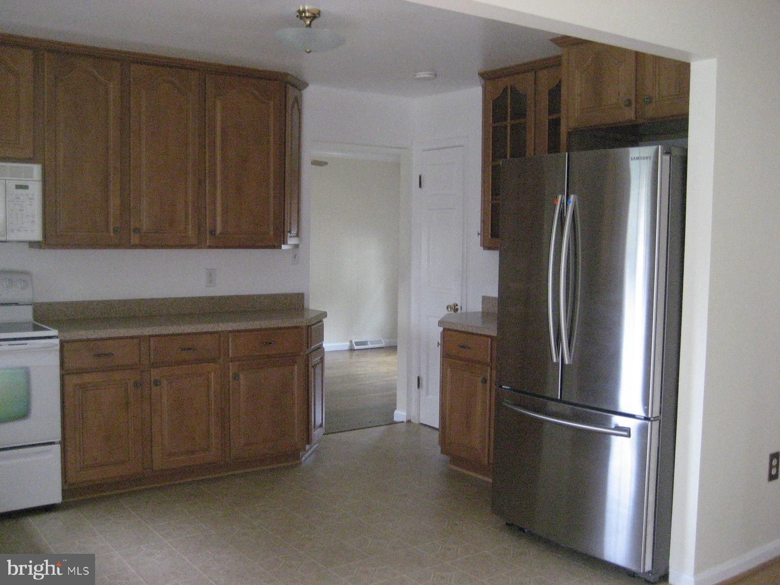 209 Dover Road Warrenton, VA 20186 - Photo 12 of 30 a kitchen with stainless steel appliances a refrigerator and cabinets