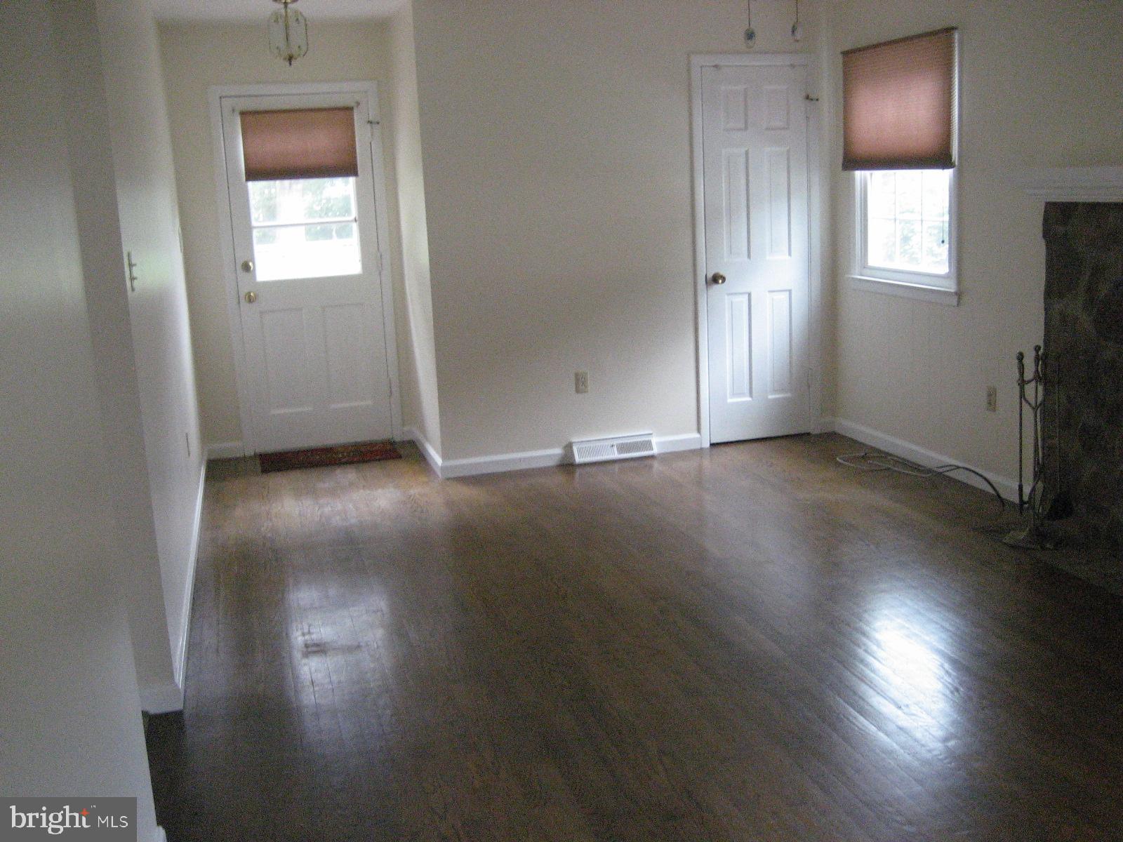 209 Dover Road Warrenton, VA 20186 - Photo 14 of 30 an empty room with wooden floor and windows