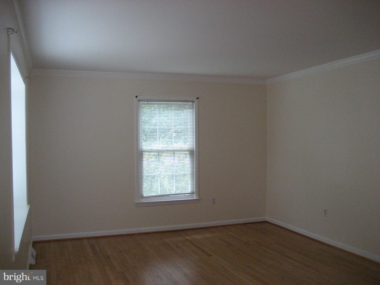 209 Dover Road Warrenton, VA 20186 - Photo 8 of 30 an empty room with wooden floor and windows