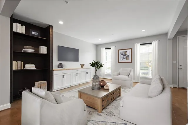 a living room with furniture a rug and a flat screen tv