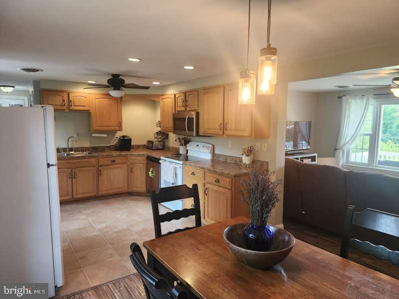 318 Long Lane Lititz, PA 17543 - Photo 5 of 26 a kitchen with stainless steel appliances granite countertop a sink a stove and a wooden floors