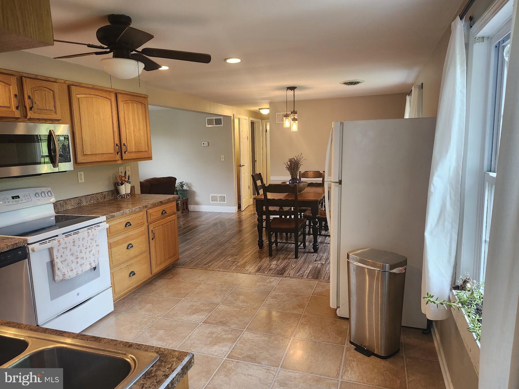 318 Long Lane Lititz, PA 17543 - Photo 6 of 26 a kitchen with stainless steel appliances kitchen island granite countertop a refrigerator and a stove top oven