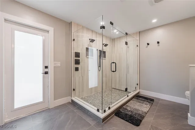 a bedroom with a large bed and a large window