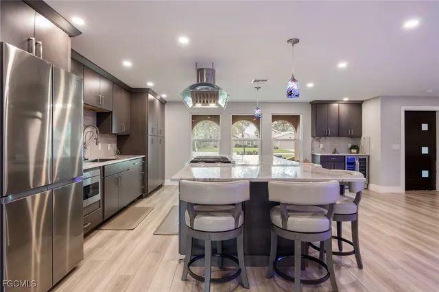 a living room with furniture and kitchen view