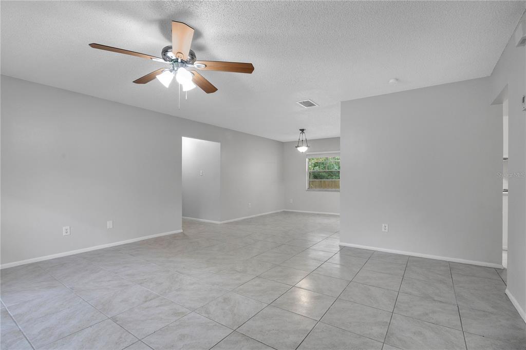 709 Sailfish Road Winter Springs, FL 32708 - Photo 11 of 28 an empty room with windows and fan