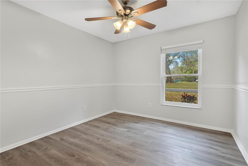 709 Sailfish Road Winter Springs, FL 32708 - Photo 12 of 28 an empty room with a window and wooden floor