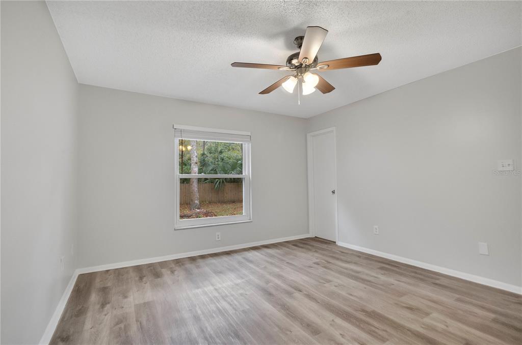 709 Sailfish Road Winter Springs, FL 32708 - Photo 15 of 28 a view of an empty room with wooden floor and a window