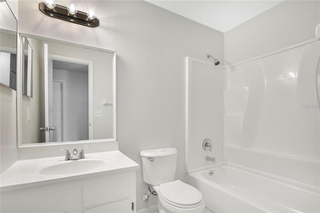 709 Sailfish Road Winter Springs, FL 32708 - Photo 17 of 28 a bathroom with a bathtub shower sink vanity mirror and toilet