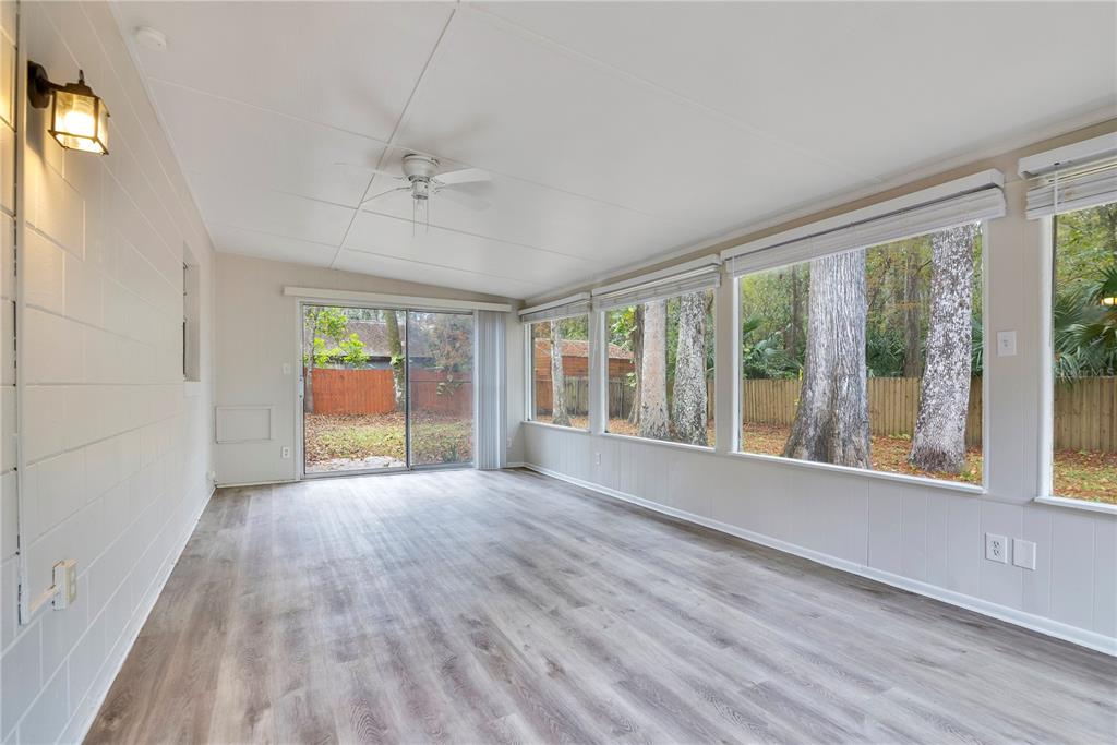 709 Sailfish Road Winter Springs, FL 32708 - Photo 18 of 28 a view of an empty room with a window and wooden floor