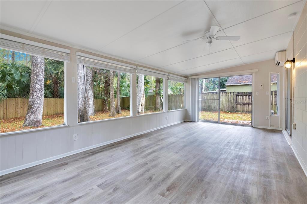 709 Sailfish Road Winter Springs, FL 32708 - Photo 19 of 28 a view of an empty room with wooden floor and a window