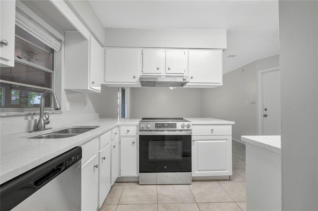 709 Sailfish Road Winter Springs, FL 32708 - Photo 9 of 28 a kitchen with cabinets appliances and a sink