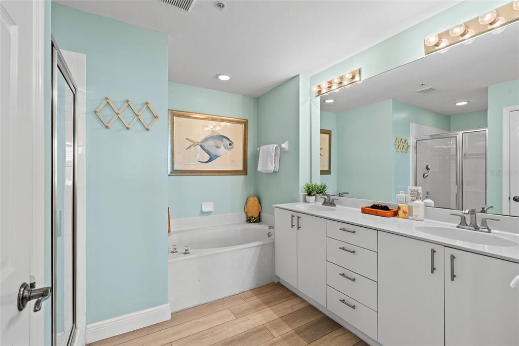 2060 Matecumbe Key Road, Unit 2106 Punta Gorda, FL 33955 - Photo 20 of 56 a bathroom with a double vanity sink mirror and bathtub